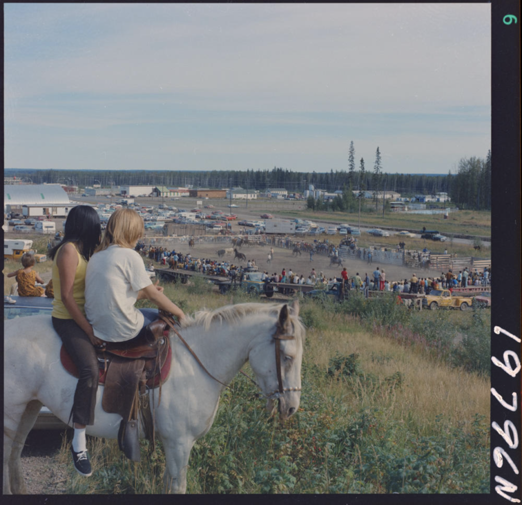 young women on horse watching rodeo in Fort Nelson